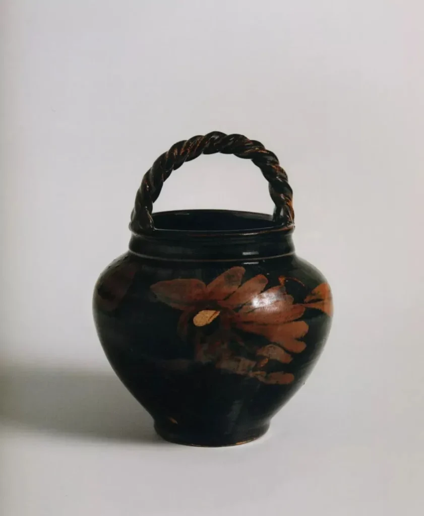 Black glazed jar with handle